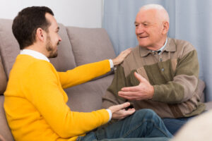 elderly father and his son is warm and friendly conversation at home
